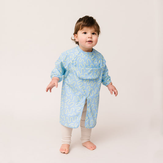 Abibi long sleeve smock bib, bright playful print, keeps clothes clean during mealtimes