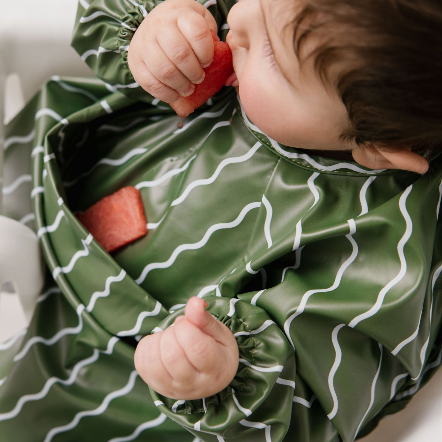 Abibi long sleeve smock bib, bright playful print, keeps clothes clean during mealtimes