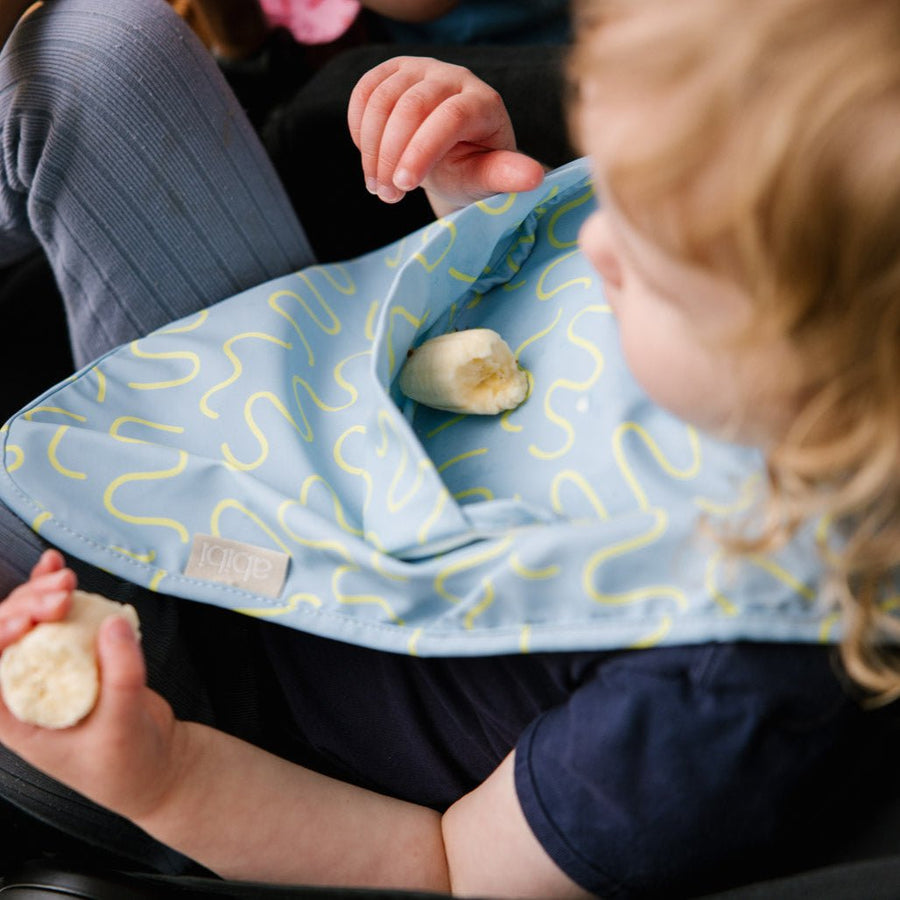 Sky Snack blue waterproof sleeveless baby feeding smock bib by Abibi - world-first mess proof design with inner collar flap